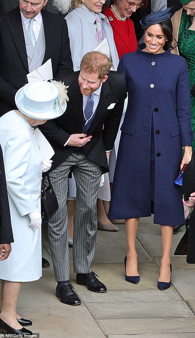 Prince Harry and Meghan Markle pictured with the Queen at Princess Eugenie's wedding in October 2018. The couple announced the pregnancy at a cocktail party after the ceremony.