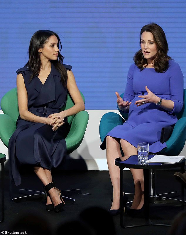 Harry writes that Meghan made the comment during the run-up to the Sussexes' wedding in May 2018. Meghan appears with Kate here in 2018 at an event in London.