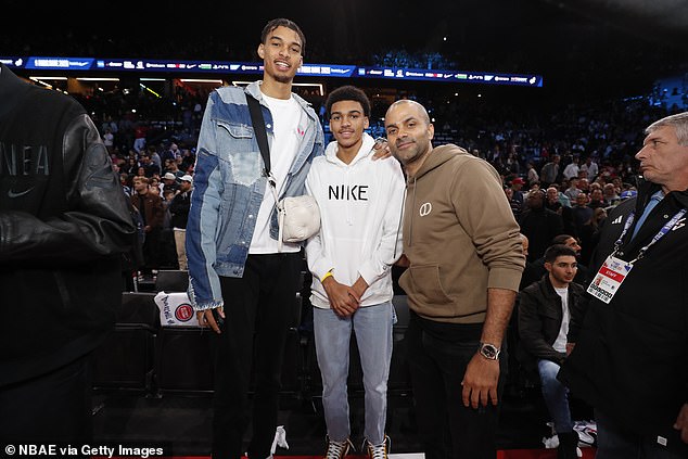 Victor Wembanyama (left), the projected No. 1 pick in the 2023 draft, stands courtside at the NBA in Paris