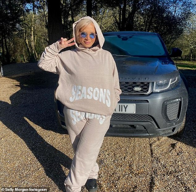 '70 is the new 20': Psychic Sally Morgan, 71, got a youthful makeover this week as she flashed a peace sign while sporting a taupe tracksuit ensemble