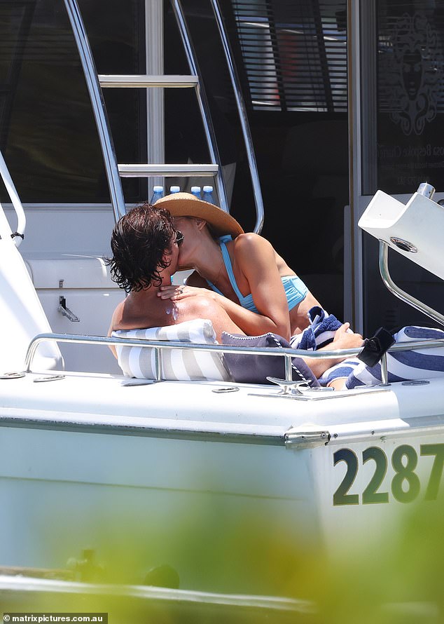 Rachael Finch and her husband Michael Miziner couldn't keep their hands off each other as they stripped down to their swimsuits for a nine-year anniversary cruise in Noosa on Monday.  In the photo