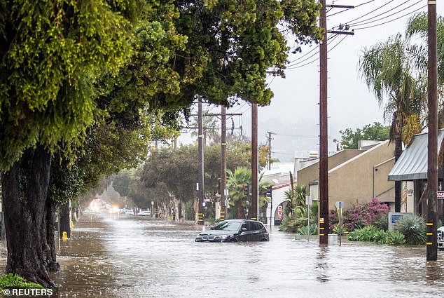 The 'relentless parade of cyclones' battering California continued overnight and was expected to move further north, the US National Weather Service said today. Pictured: Abandoned cars are left on a flooded street in the east santa barbara