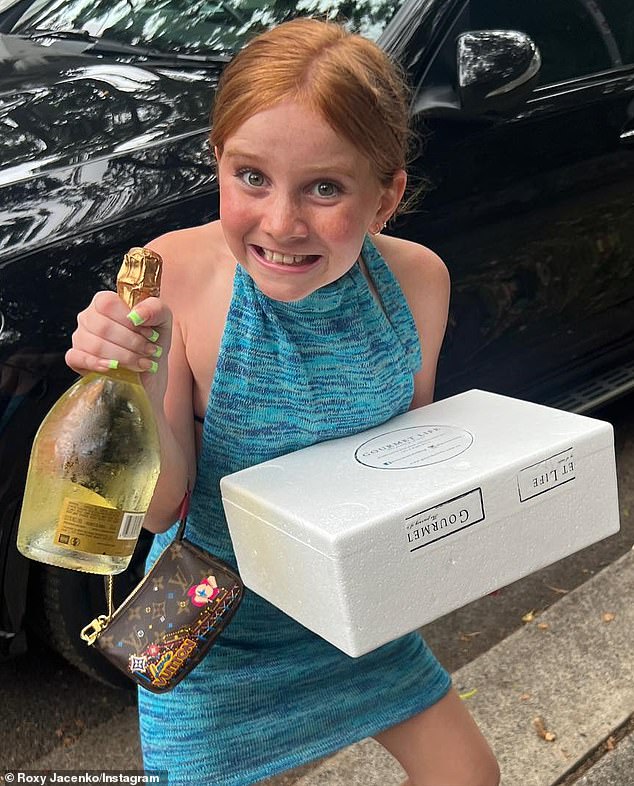 The photo showed Pixie smiling for the camera while holding an unopened bottle of Ruinart champagne in one hand and what appeared to be a cooler of food in the other.