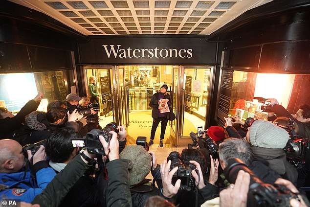 Caroline Lennon, the first customer to buy a copy of Spare, leaving the Waterstones in Piccadilly Circus this morning