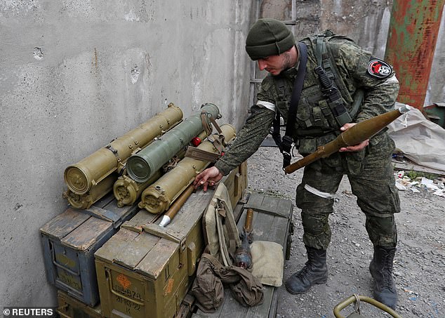 Pro-Russian troops with a rocket-propelled grenade in Mariupol, Ukraine, in May 2022. High explosives have been a regular feature of Russia's campaign in Ukraine since last year.