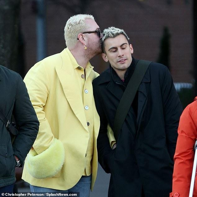 Kiss-kiss: Sam Smith put his flamboyant sense of style on display when they stepped out with designer Christian Cowan in New York City on Sunday, ahead of his Saturday Night Live concert.