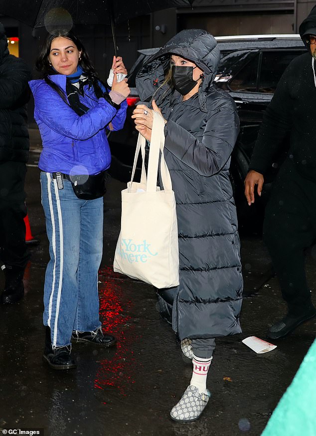 Covered: Sarah Jessica Parker was nearly unrecognizable as she braved rainy Northeast weather Thursday night