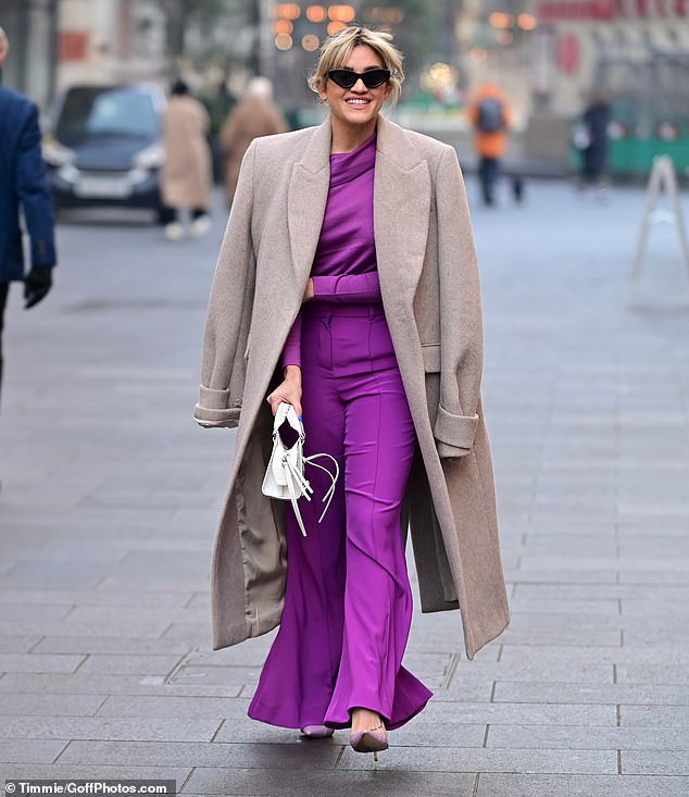 Cheeky: Ashley Roberts joked that she looks like the eggplant emoji when she left Heart FM while wearing purple sparklers on Monday morning