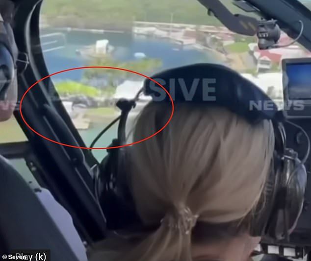 The footage appears to show that the helicopter being lifted may have been hidden from the surviving pilot's line of sight by the cockpit fuselage.