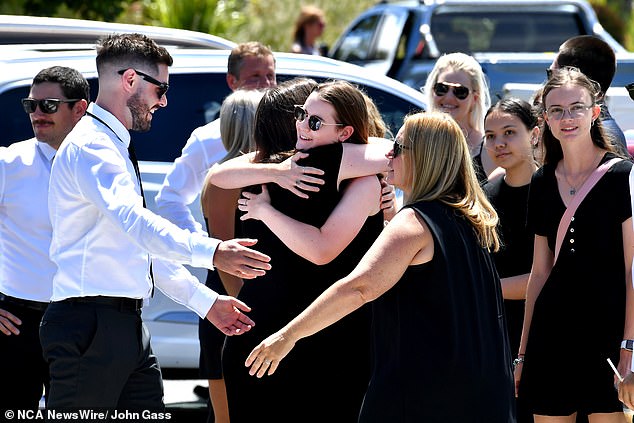 Mourners greet each other outside Southport Christ Church on Friday for the funeral of Sea World helicopter pilot Ashley Jenkinson.