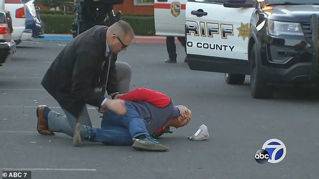 Zhao Chunli, 67, is pictured Monday afternoon as he is arrested by San Mateo County officials.