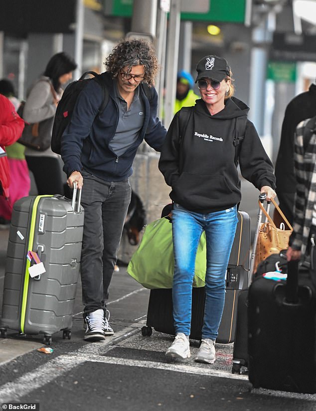 Happily ever after: Shania Twain looked relaxed as she arrived at John F. Kennedy International Airport in New York City with her husband Frédéric Thiébaud on Tuesday after celebrating their 12th anniversary on New Year's Day.