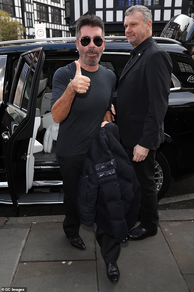 Low key: The TV mogul was one of the first to arrive at the London Palladium as he gave a thumbs up to the crowd