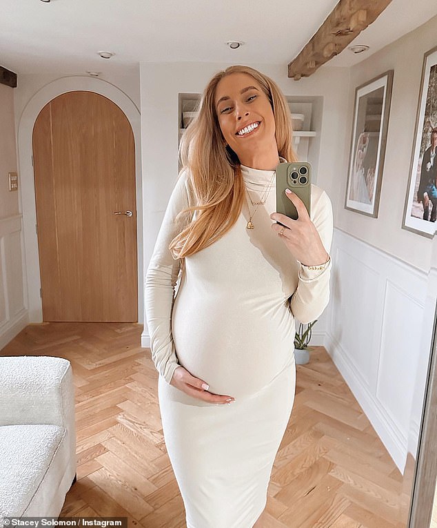 Coming along nicely: Stacey Solomon showed off her growing baby bump in a form-fitting cream dress on Friday, as she counted down the days until the birth of her little one