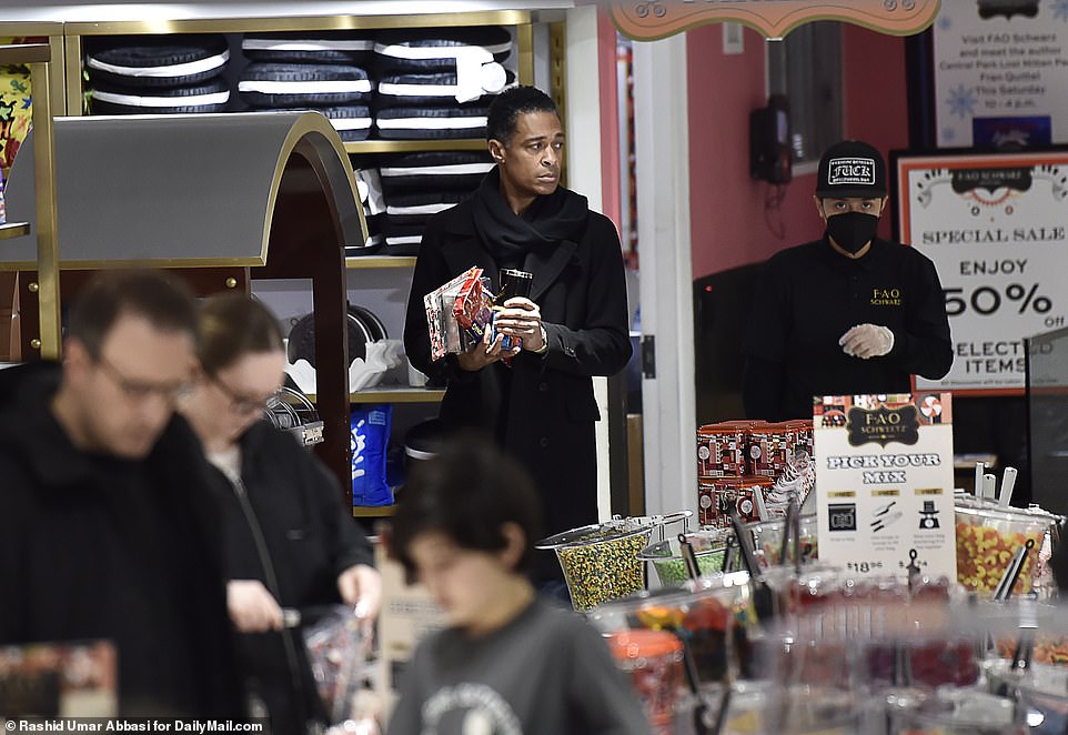 TJ Holmes was seen shopping for gifts at the iconic New York City toy store FAO Schwarz on Thursday, exclusive photos from DailyMail.com show