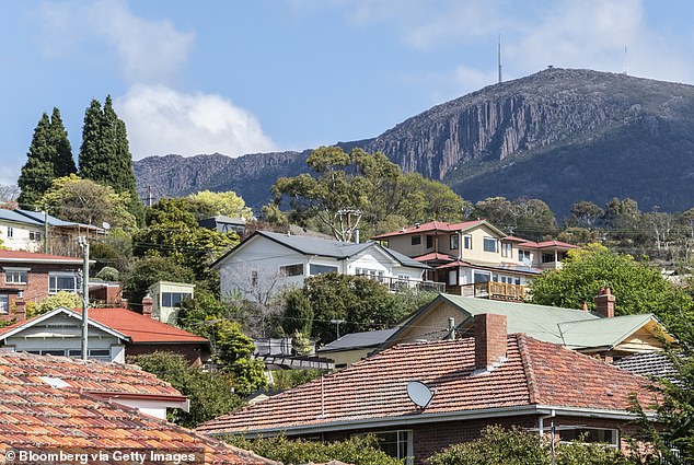 Potential renters in Tasmania, desperate for a roof over their heads, feel 'hopeless' and 'depressed' as they spend months facing rejected applications and crowds of '40-50 people' showing up (pictured, houses in Hobart )