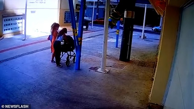 CCTV footage shows pedestrians standing in the street below the first floor car park in Balneario Camboriú, Brazil, yesterday.