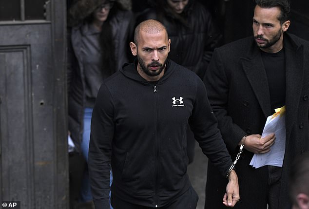 Andrew Tate, center, and his brother Tristan, leave after appearing in the Court of Appeal, in Bucharest, Romania, on January 10.