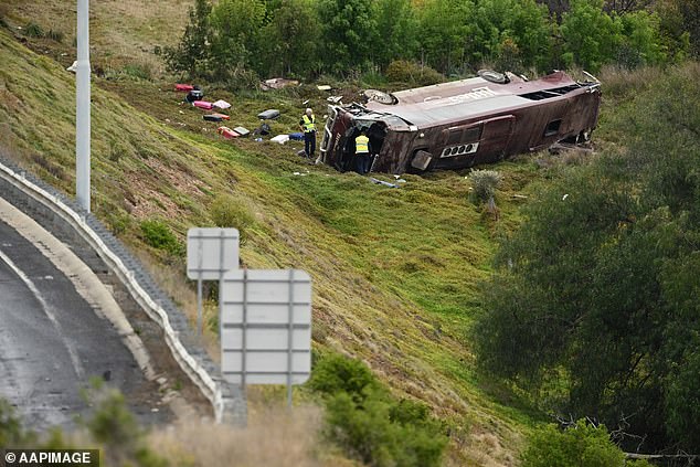 The school bus, carrying 27 students and four teachers, rolled 50m behind it and a truck collided in the confusion of a previous truck crash (pictured, emergency services on scene)