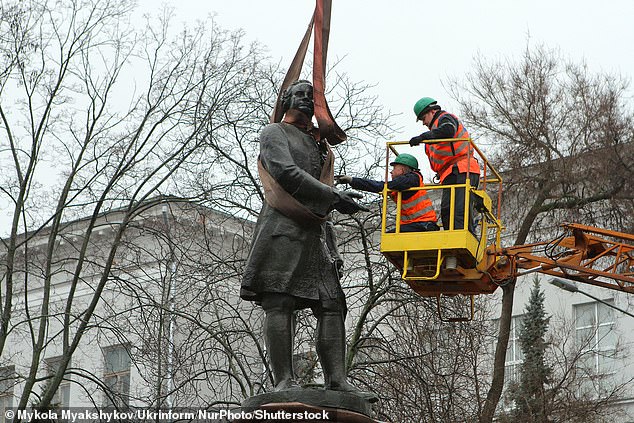 Utility workers dismantle the monument to Russian scientist Mikhail Lomonosov with the help of special equipment, Dnipro, Ukraine, January 6, 2022