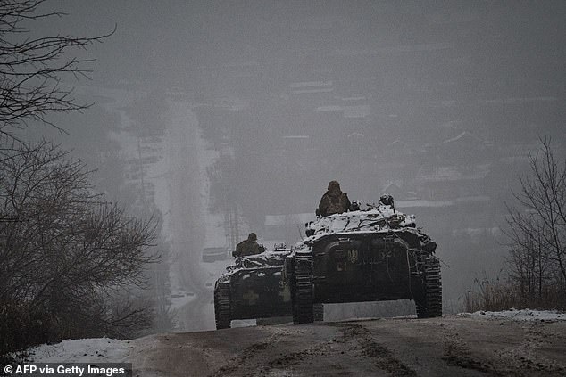 Vladimir Putin's war in Ukraine is nowhere near over, and will continue to drag on and become even bloodier, former Royal Navy chief Admiral Lord Alan West has warned.  Pictured: Ukrainian soldiers drive armored vehicles on an icy road in the Donetsk region.