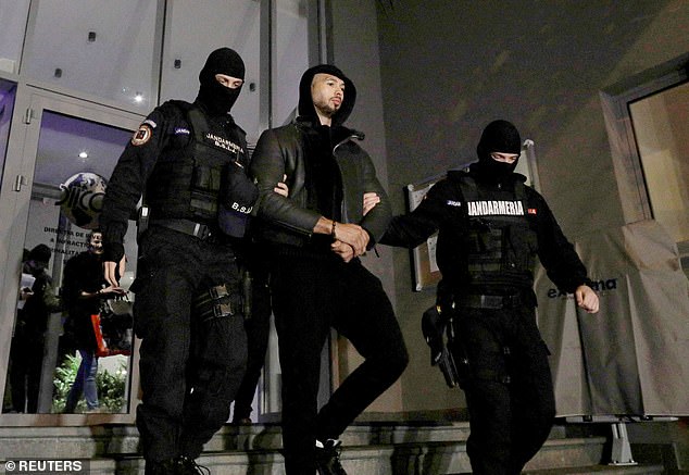 Andrew Tate has complained about the conditions in his prison cell.  Pictured: Tate is escorted by police after being detained in Bucharest, Romania, on December 29, 2022.