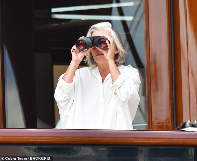 The actress was seen using binoculars to get a better look and started waving to get someone's attention