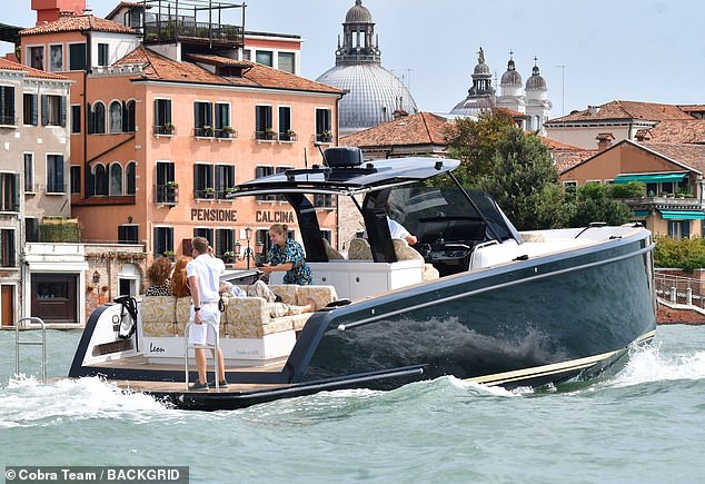 Dame Emma was seen with friends on a smaller boat as they traveled the waters of Venice