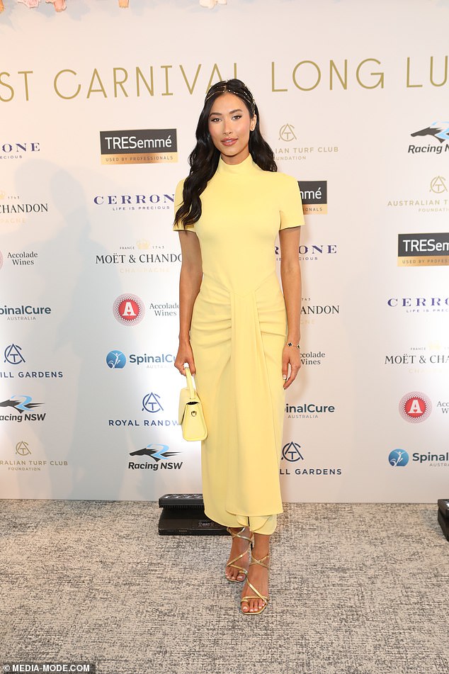 Meanwhile, the model hugged her figure in a pastel yellow dress with a ruffled waist and fabric waterfall detail at the front