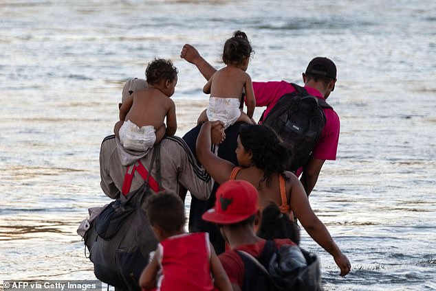 Migrants — including young children still wearing diapers — cross the Rio Grande into the United States on August 4, 2023