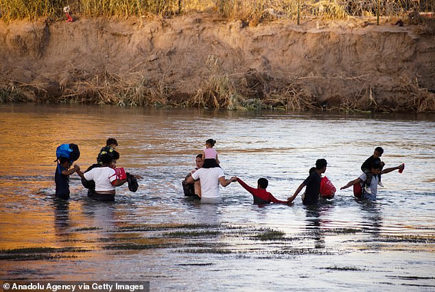 Migrant families try to cross the border between Piedras Negras and Eagle Pass in Piedras Negras, Mexico on August 4, 2023