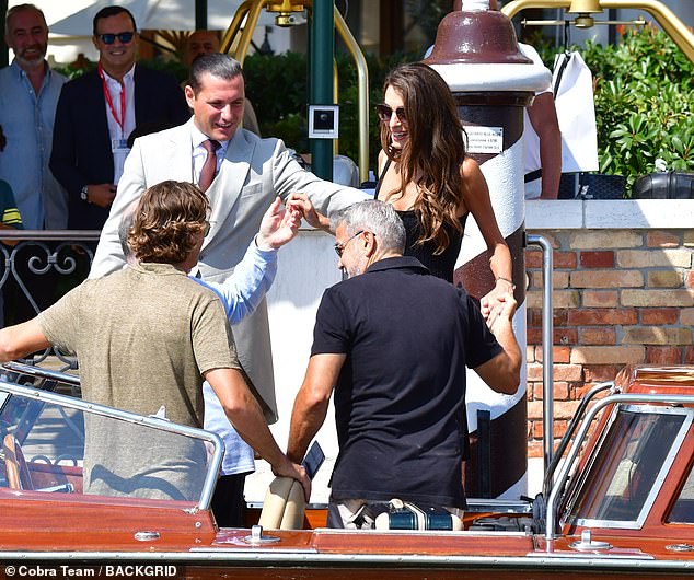 Soaking up the sun: Everyone seemed in a good mood as they boarded the boat