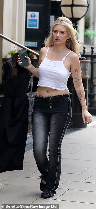 Chic: During the last week of filming, Lottie opted for a white cami top with low-rise jeans.