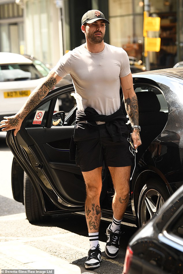 Filming: Meanwhile, Adam looked casual in a gray T-shirt and baseball cap as he arrived in a separate car