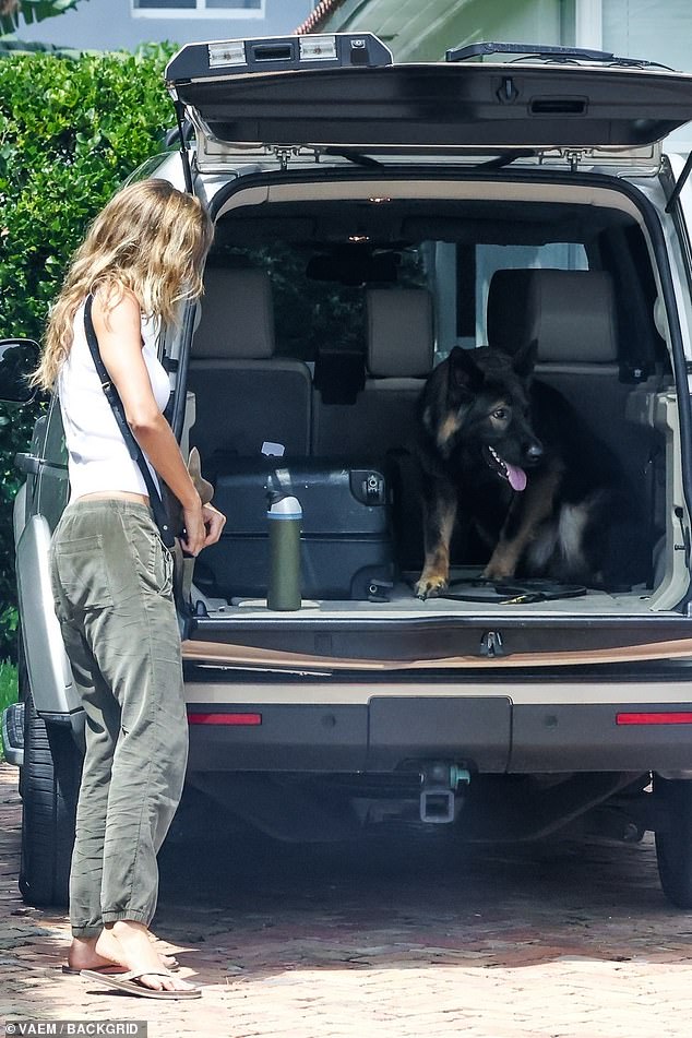 Loving dog mom: At one point, you could see her holding a leash as she opened the spacious trunk of her car, where her dog was chilling, next to a small suitcase