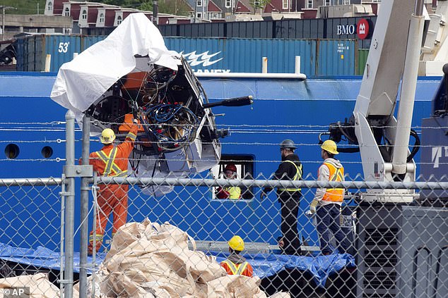 Debris from the Titan submarine, recovered from the ocean floor near the wreckage of the Titanic, is unloaded from the ship Horizon Arctic at the Canadian Coast Guard pier