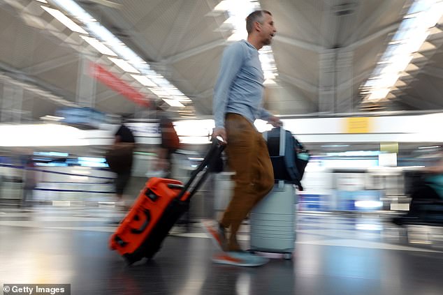 More than 20 million people are expected to leave the state this Labor Day weekend, according to travel booking app Hopper — an 11% increase from last year.  (Pictured: A passenger at O'Hare International Airport on Friday)