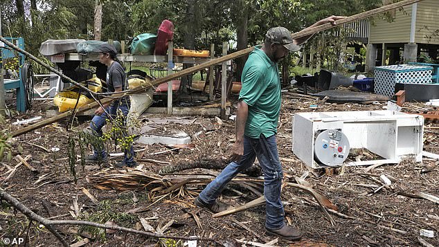 Entire towns were flattened by the hurricane, while residents of Cedar Key, Florida (pictured) were tasked with clearing the tornado's debris