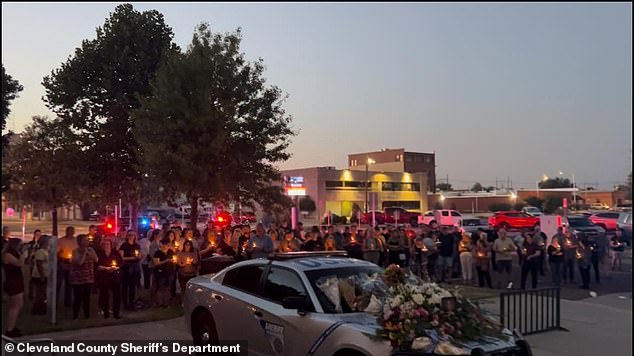 Dozens of mourners turned out for a candlelight vigil in honor of the slain officer