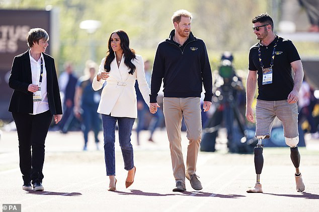 The Duke and Duchess of Sussex, with Invictus Games trustee and Paralympian Dave Henson (right), attend the 2022 Invictus Games in The Hague, Netherlands