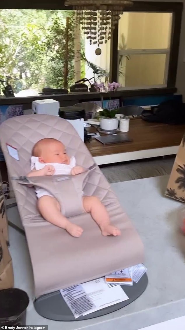 Precious: Jenner turned his attention to their newborn, capturing Honey reclining in her stroller, which sat on a kitchen counter