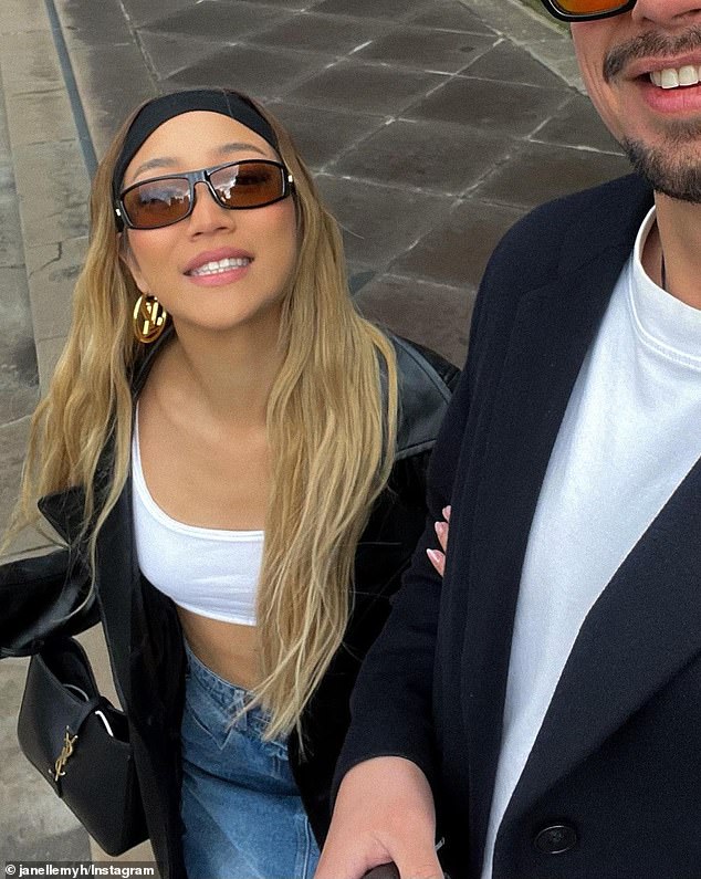 The beauty influencer sparked romance rumors last month after she uploaded a photo of her getting cozy with a mystery man (right)