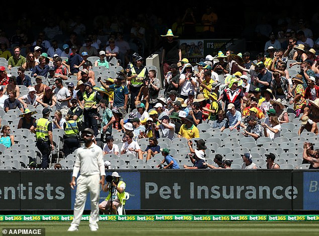 Police stand alongside rowdy crowd members during the Boxing Day Test at the MCG in 2018, where a group of supporters were sent off for racist abuse against Indian players