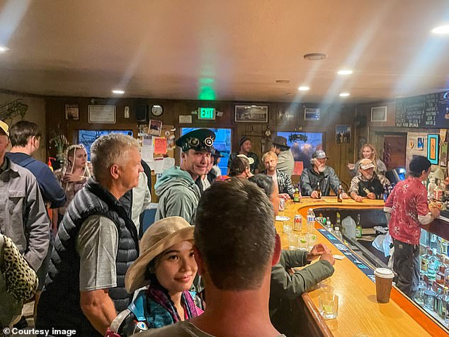 Some people can be seen with their luggage in the bar as the organizers did not allow anyone to enter or leave the premises