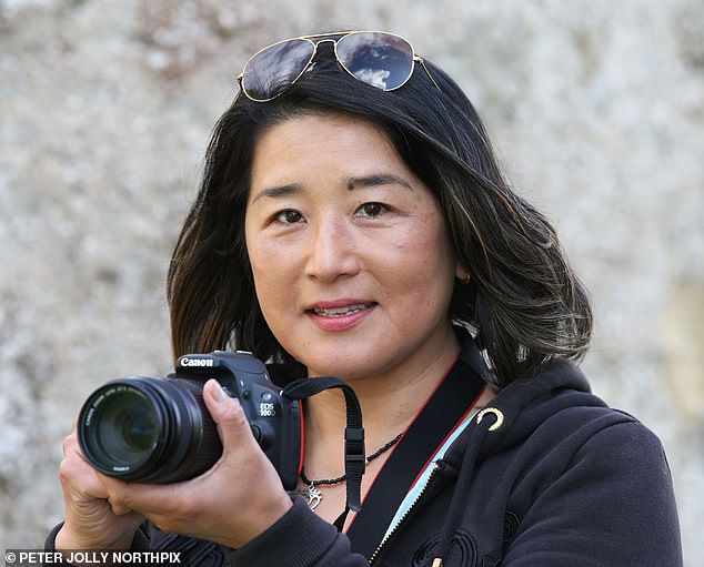 Chie Kelly, 51, was taking pictures from the village of Dores when she and her husband, businessman Scott, 68, saw a strange 'snake-like' creature moving for a distance of about 100 meters before disappearing