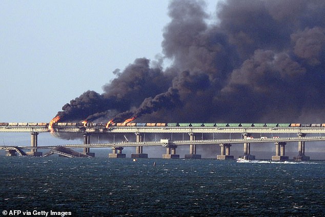 Black smoke rises from a fire on the Kerch Bridge connecting Crimea to Russia, near Kerch, on October 8, 2022