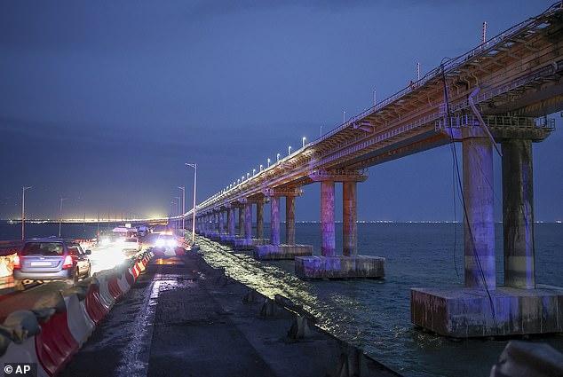 Cars drive on the Crimean bridge connecting Russia and the Crimean peninsula in the Kerch Strait, on the Taman Peninsula in the Krasnodar region of Russia, October 8, 2022