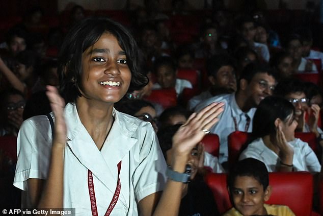 A student celebrates after watching the live stream of the launch of the PSLV XL rocket carrying the Aditya-L1 spacecraft