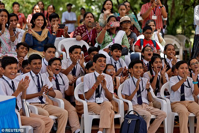 Schoolchildren react as they watch the Aditya-L1 spacecraft launch live