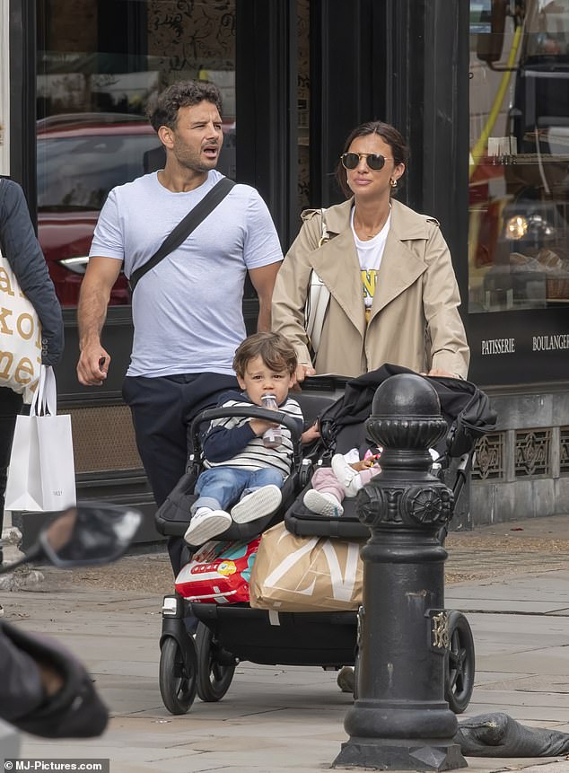 Chic: She pulled her brunette hair into a neat bun and shielded her eyes with a pair of aviator sunglasses